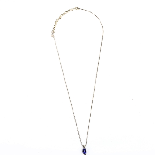 426 - A modern 18ct white gold tanzanite and diamond pendant necklace, set with oval mixed-cut tanzanite a... 