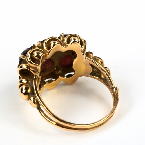 430 - A large unmarked gold garnet dress ring, set with round-cut garnets, setting height 17.3mm, size Q, ... 