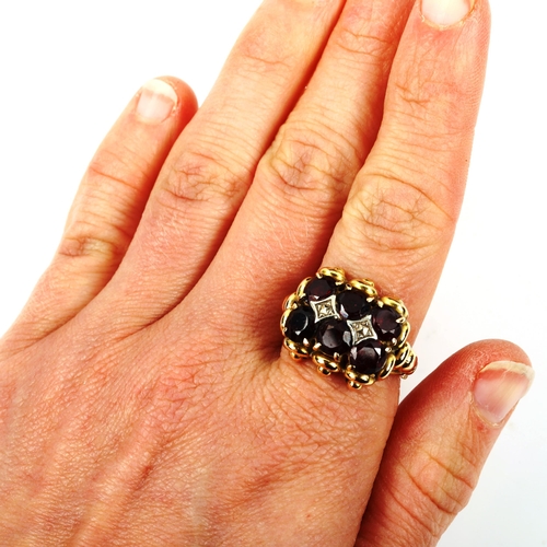 430 - A large unmarked gold garnet dress ring, set with round-cut garnets, setting height 17.3mm, size Q, ... 