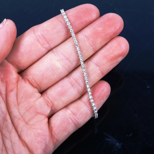 437 - A modern 18ct white gold diamond tennis line bracelet, set with modern round brilliant-cut diamonds,... 