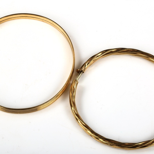 438 - A 9ct gold slave bangle, band width 5.7mm, internal diameter 6.5cm, 13g, and an unmarked yellow meta... 