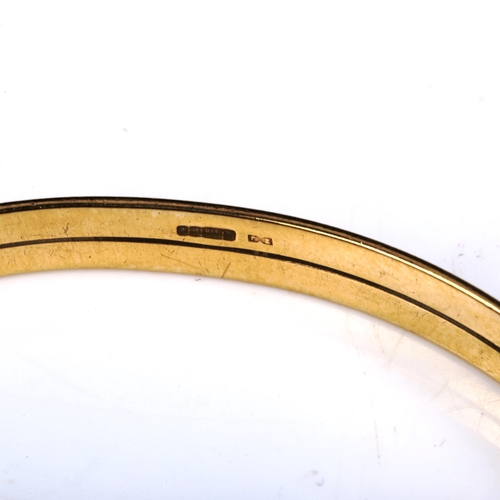 438 - A 9ct gold slave bangle, band width 5.7mm, internal diameter 6.5cm, 13g, and an unmarked yellow meta... 