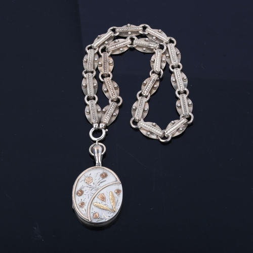 439 - A Victorian sterling silver photo locket pendant necklace, with applied gold floral decoration, on f... 