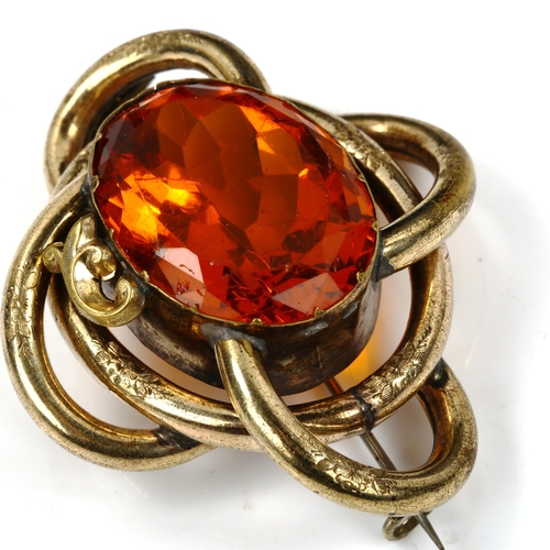 441 - A large Victorian gilt-metal citrine knot brooch, brooch length 61.8mm, 35.7g