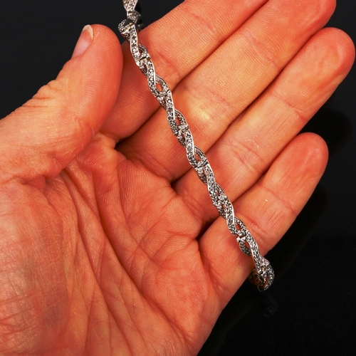 443 - A modern silver-gilt diamond twist tennis bracelet, bracelet length 19cm, 9.5g