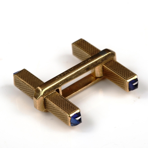 449 - ASPREY - an Art Deco 9ct gold sapphire single cufflink, allover engine turned decoration with pyrami... 