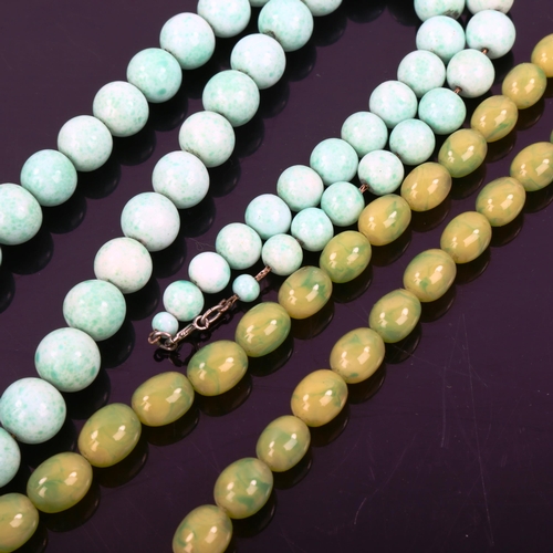 509 - A 1930s mottled green uranium glass bead necklace, and a graduated single-strand hardstone bead neck... 