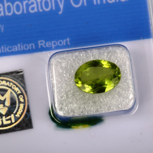 523 - An unmounted 2.3ct oval mixed-cut peridot, 10.40mm x 7.30mm x 4.30mm, with GLI report card