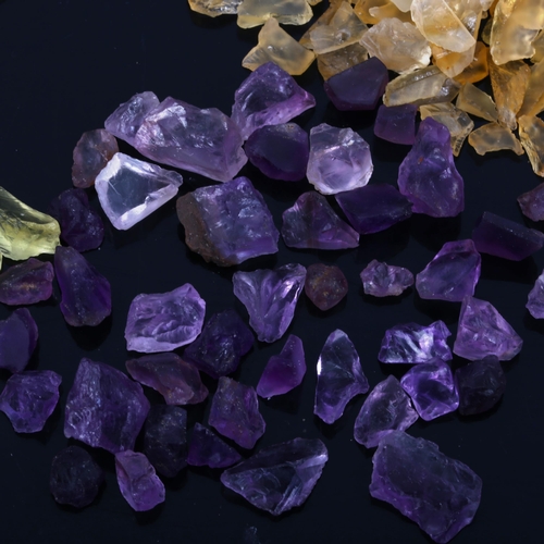 527 - A quantity of unmounted rough gemstones, including amethyst, lemon quartz and citrine