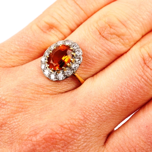 542 - An 18ct gold citrine and diamond oval cluster ring, set with oval mixed-cut citrine and modern round... 