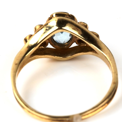 547 - A modern 9ct gold blue topaz and diamond dress ring, set with oval mixed-cut topaz and modern round ... 