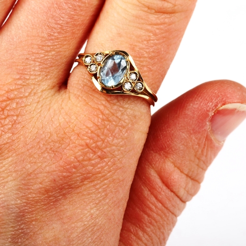 547 - A modern 9ct gold blue topaz and diamond dress ring, set with oval mixed-cut topaz and modern round ... 