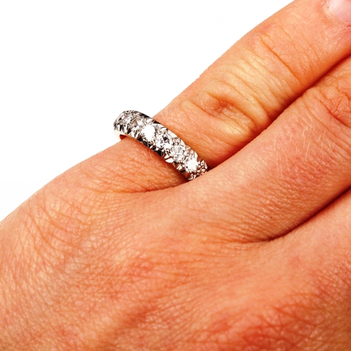 551 - An 18ct gold nine stone half eternity ring, set with modern round brilliant-cut diamonds, total diam... 