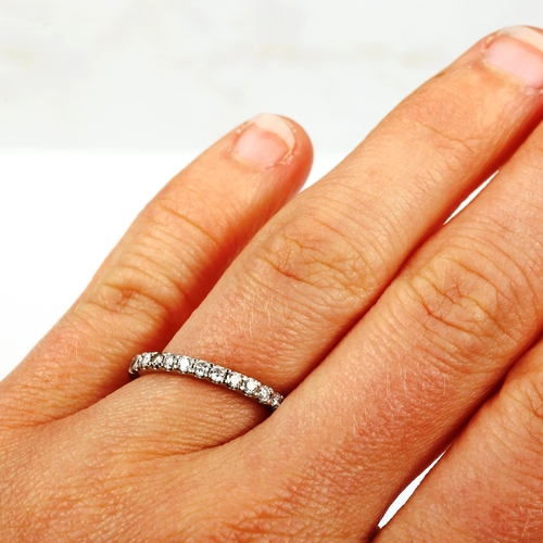 552 - A modern 18ct white gold diamond half eternity ring, set with modern round brilliant-cut diamonds, t... 