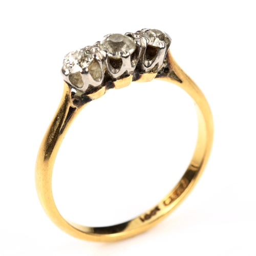 556 - An 18ct gold three stone diamond ring, set with old European-cut diamonds, total diamond content app... 