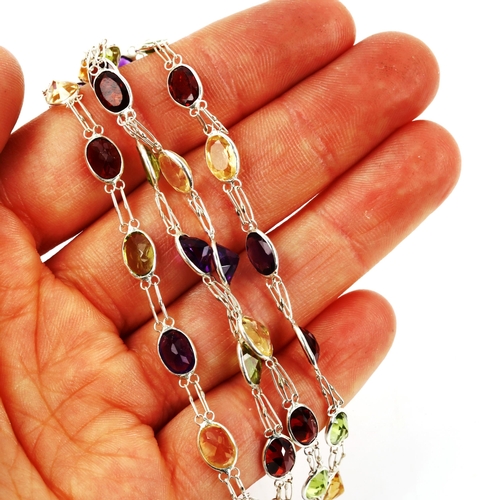 606 - A modern silver gem set line necklace, gemstones include peridot amethyst citrine and garnet, neckla... 