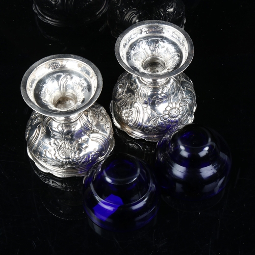 737 - A pair of George III Irish silver pedestal salt cellars, with blue glass liners and relief embossed ... 