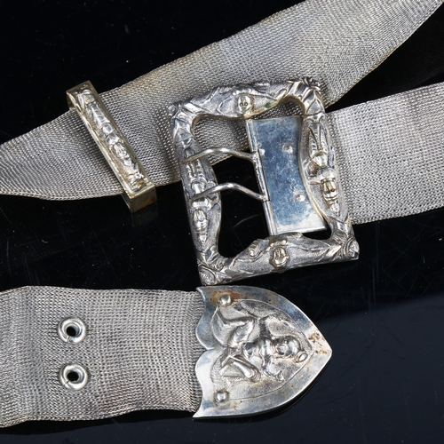 743 - An Indian unmarked silver mesh belt, with cast figural buckle and slide, length 80cm, 7.9oz