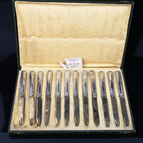 747 - A cased set of 12 French silver-handled knives, length 17cm, with original label