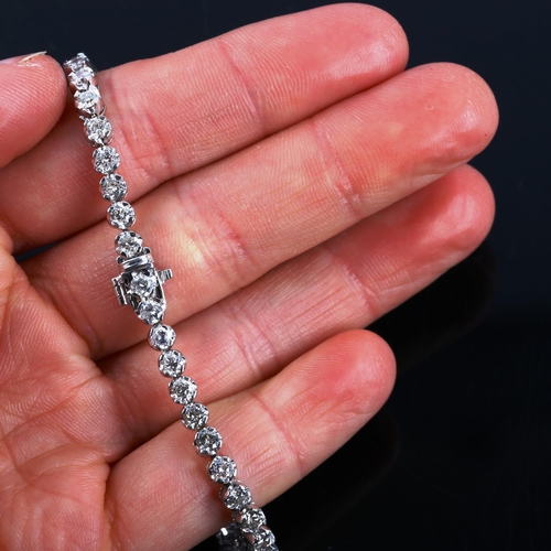 327 - A modern 18ct white gold diamond tennis line bracelet, set with modern round brilliant-cut diamonds,... 