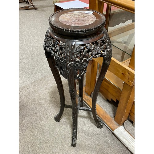 1016 - A Chinese rosewood jardiniere stand, late 19th century, with inset marble top and carved and pierced... 