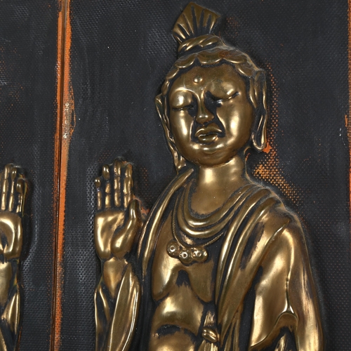 63 - A pair of relief embossed brass figural Buddhist plaques, 84cm x 24cm