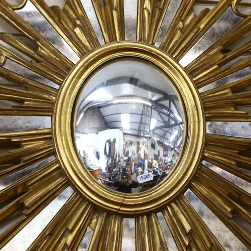 67 - A large gilt-framed sunburst convex wall mirror, 85cm x 64cm