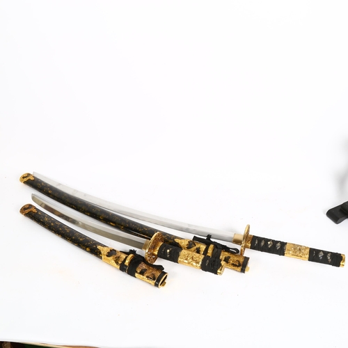 79 - A pair of reproduction Samurai swords, on display stand