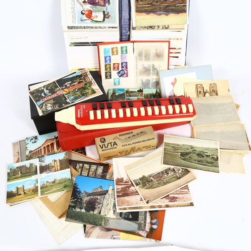 103 - Postage stamps, postcards, and a Hohner Melodica-Alto harmonica