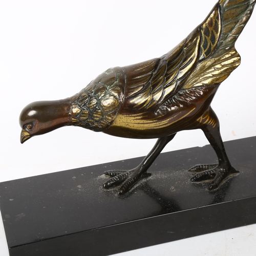 221 - An Art Deco style patinated spelter sculpture, prowling pheasant, unsigned, on black slate base, len... 