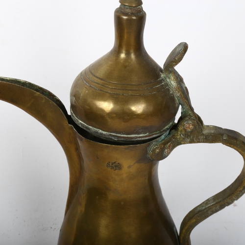 225 - A 19th century copper jam pan, and a Turkish brass ewer, height 26cm (2)