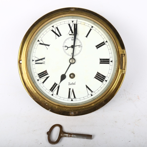 243 - A brass ship's bulkhead clock, by Sestrel, dial diameter 15.5cm, working order, with key