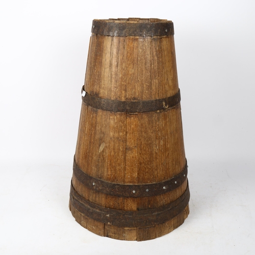 306 - A tapered coopered oak stick stand, height 50cm