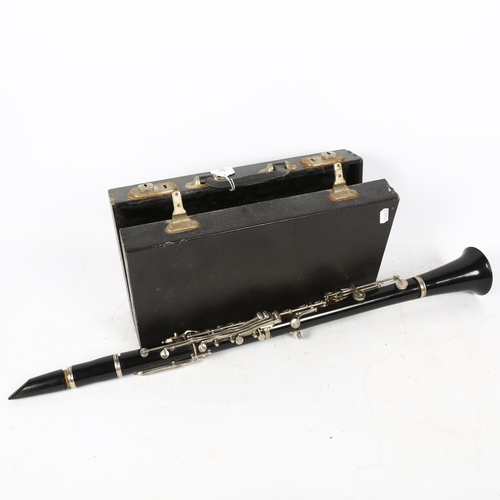 338 - A black lacquer clarinet, in fitted hardwood case