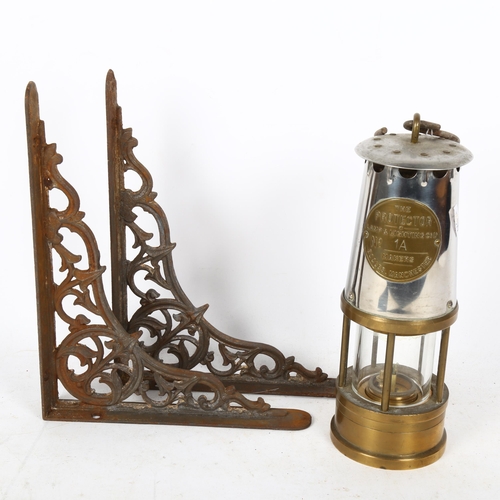 350 - An early 20th century chrome and brass Protector miner's oil lamp, and a pair of cast-iron wall brac... 