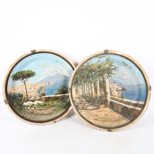 368 - A large pair of Italian hand painted pottery landscape chargers, with Mount Vesuvius scenes, unsigne... 