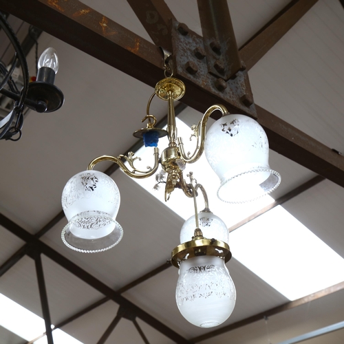 609 - A pair of wrought-metal 5-light chandeliers, 46cm diameter approx, and a brass light fitting