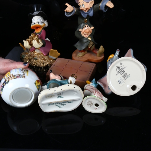 490 - A group of Disney figures, including Mickey Mouse and Donald Duck, a Winnie The Pooh money box, and ... 