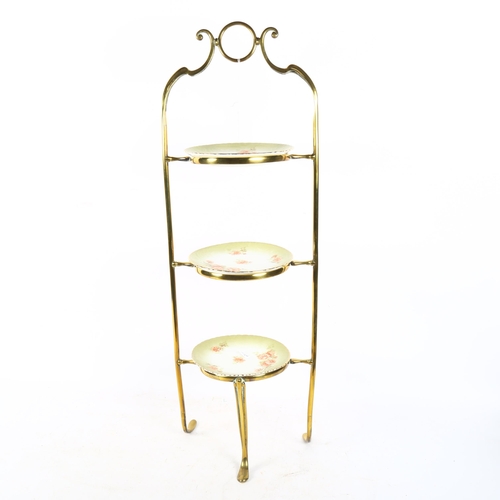503 - A brass cake stand with 3 porcelain plates, height 73cm