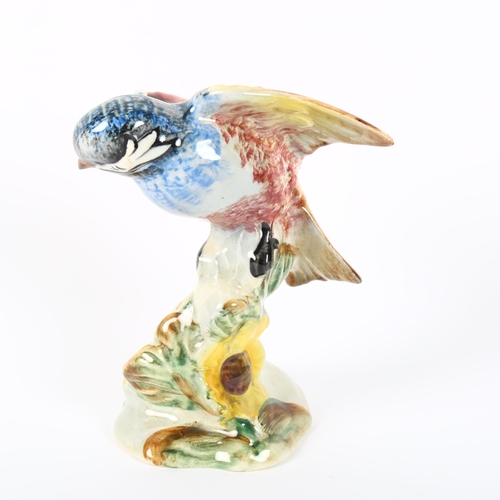 532 - A Beswick bird perched on a yellow flower, 929