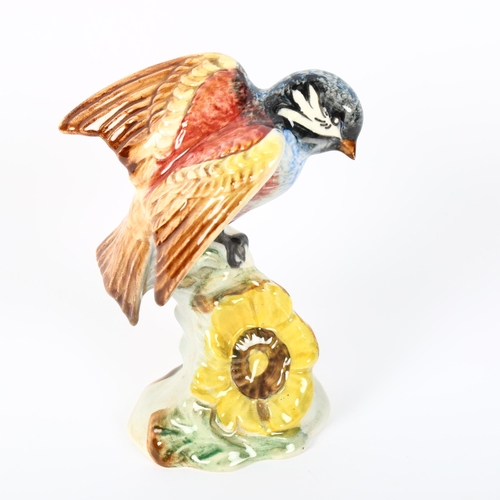 532 - A Beswick bird perched on a yellow flower, 929