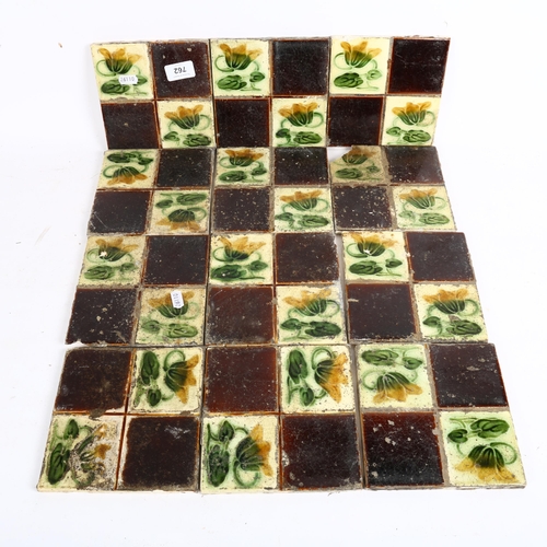 762 - 12 Art Nouveau floral pottery tiles, 16cm x 16cm