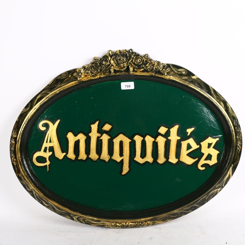 799 - An oval painted wood Antiquities sign, 67cm across