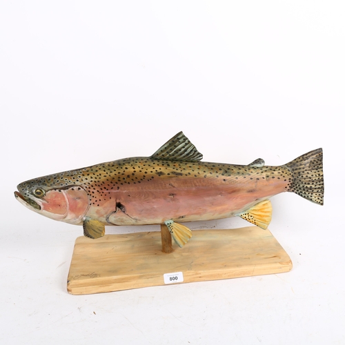 800 - A carved and painted wooden salmon on stand, by Clive Fredriksson, length 63cm