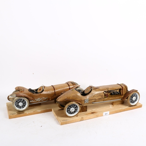 801 - Clive Fredriksson, 2 carved and painted wood veteran car sculptures, on pine plinths, length 47cm