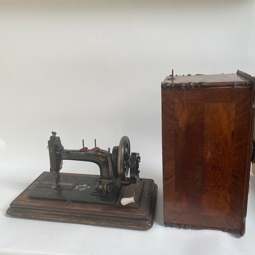 485 - An Antique sewing machine, in inlaid wooden case