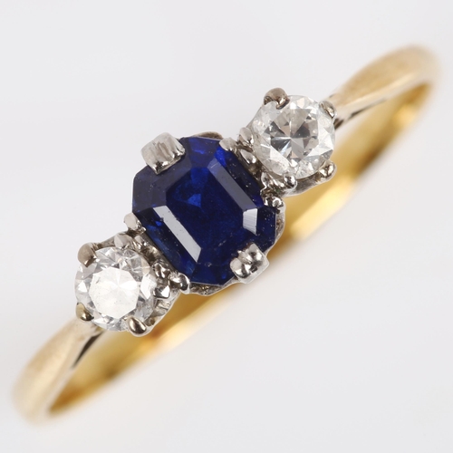 113 - A three stone sapphire and diamond ring, unmarked gold settings with emerald-cut sapphire and modern... 