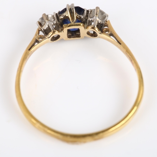 113 - A three stone sapphire and diamond ring, unmarked gold settings with emerald-cut sapphire and modern... 