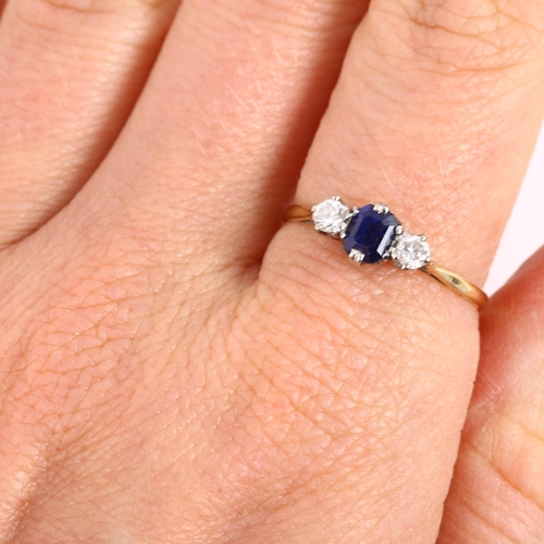 113 - A three stone sapphire and diamond ring, unmarked gold settings with emerald-cut sapphire and modern... 