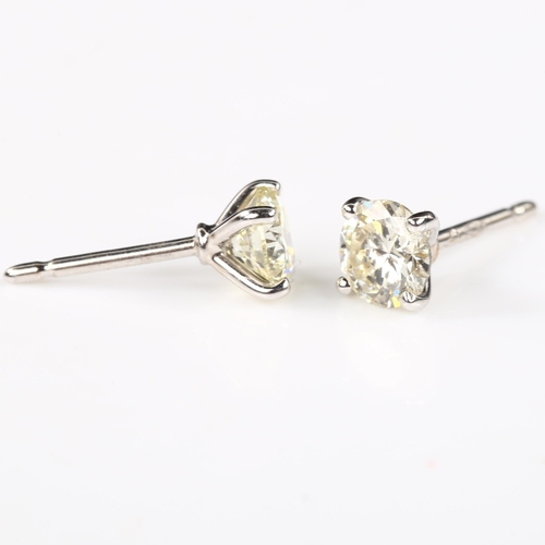 116 - A pair of 18ct white gold 1.01ct solitaire diamond stud earrings, plain 4-claw setting with modern r... 